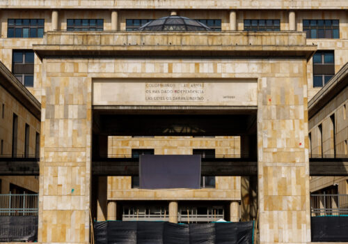 Facade of the Palace of Justice in the main square of Bogota, Colombia with the caption "Colombians, weapons gave you independence, laws will give you freedom."