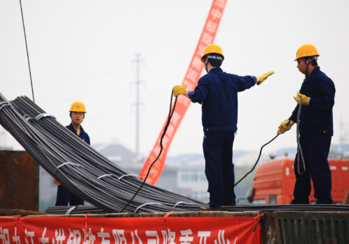 In China's eastern city of Jiujiang, workers in the steel building materials market hoisting steel.